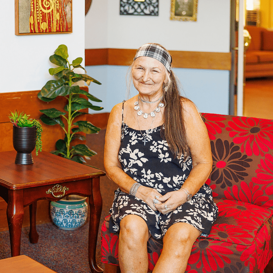 a woman sitting on a red couch