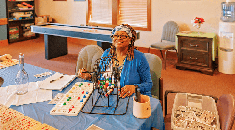 a woman sitting at a table with a caged game