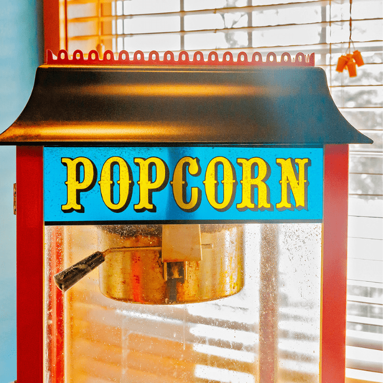 a popcorn machine in front of a window