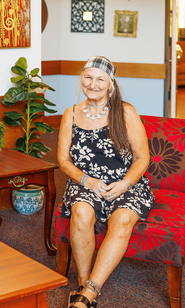 a woman sitting on a red couch