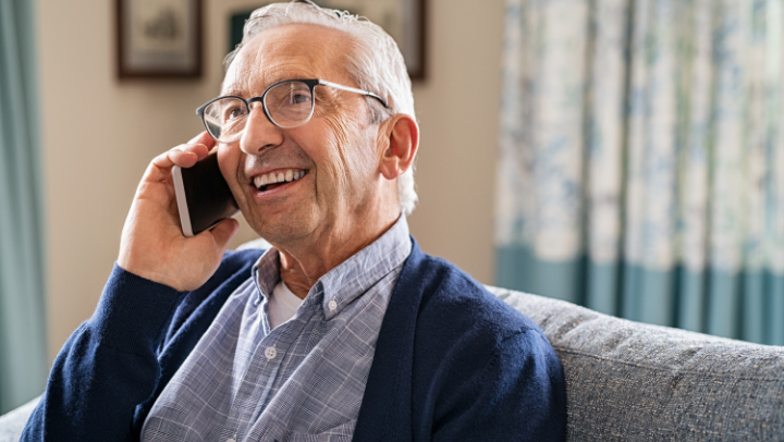 old men speaking at the phone.
