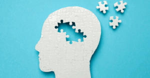 a puzzle of a head with pieces coming off it