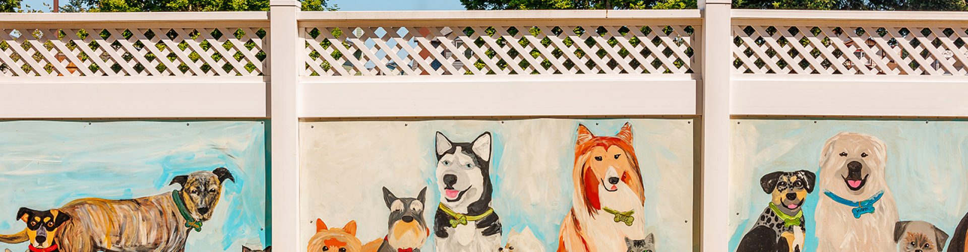 a fence with a painting of dogs