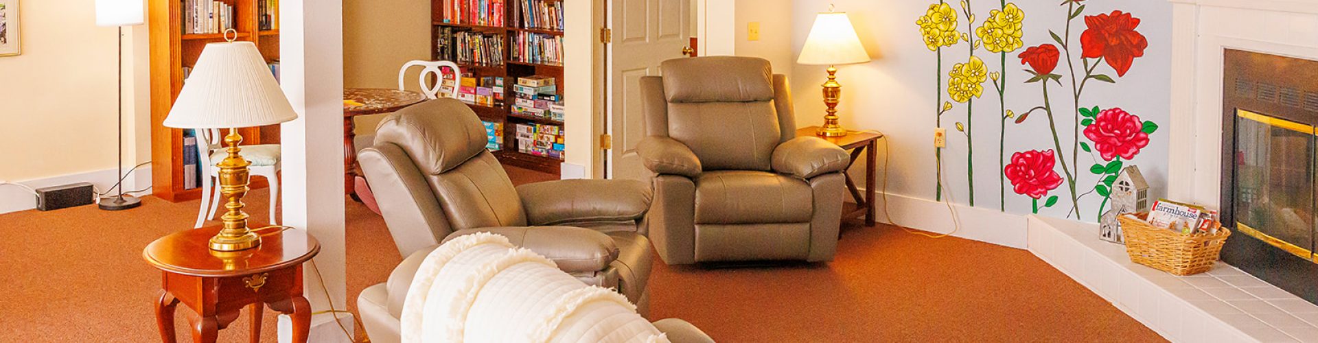 a room with a bookcase and chairs